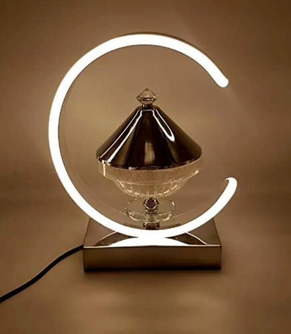 Decorative lamp with a crescent moon design on a brown background